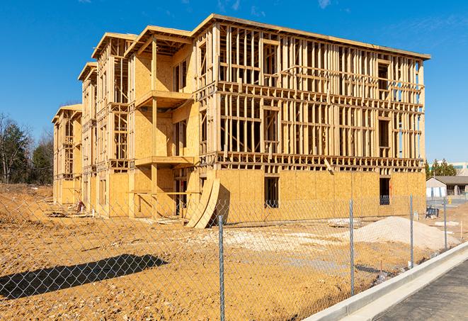 a temporary chain link fence locking away a building under renovation, serving as a security tool in Lasara TX